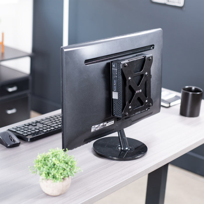 Mount Designed for Dell OptiPlex Micro on back of freestanding monitor on desk.