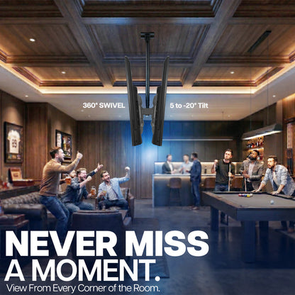 Modern living room with people around a pool table, featuring a large TV mounted on the ceiling.