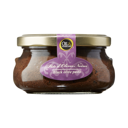 A glass jar containing black olive paste with a label indicating it is 'Black olive paste' and has net contents of '180g/6.3oz'.