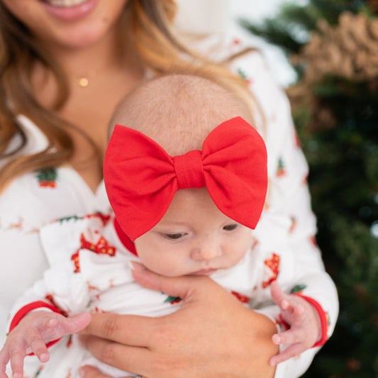 Close up of the Bow Headband in Cardinal shown on an infant