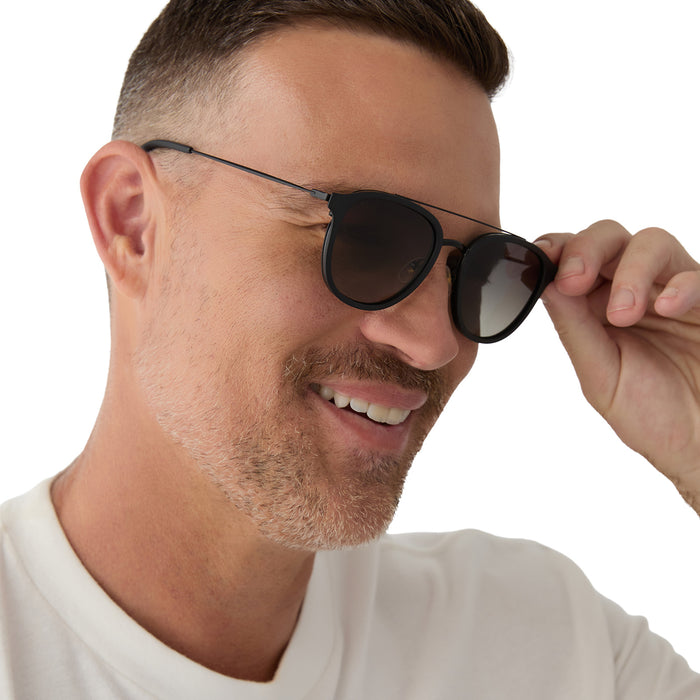 on model - male wearing diff eyewear camden matte black grey gradient polarized sunglasses angled view