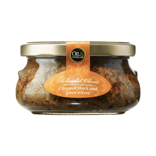 A glass jar containing chopped black and green olive paste with visible pieces of olives and seasonings.