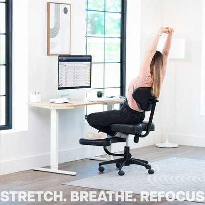 Person stretching on an ergonomic chair in a home office setting