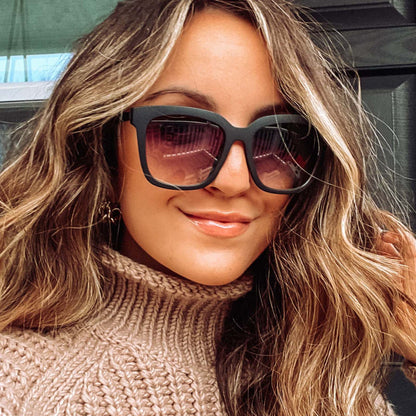 lifestyle - woman wearing Hailey in matte black with grey gradient sharp lens