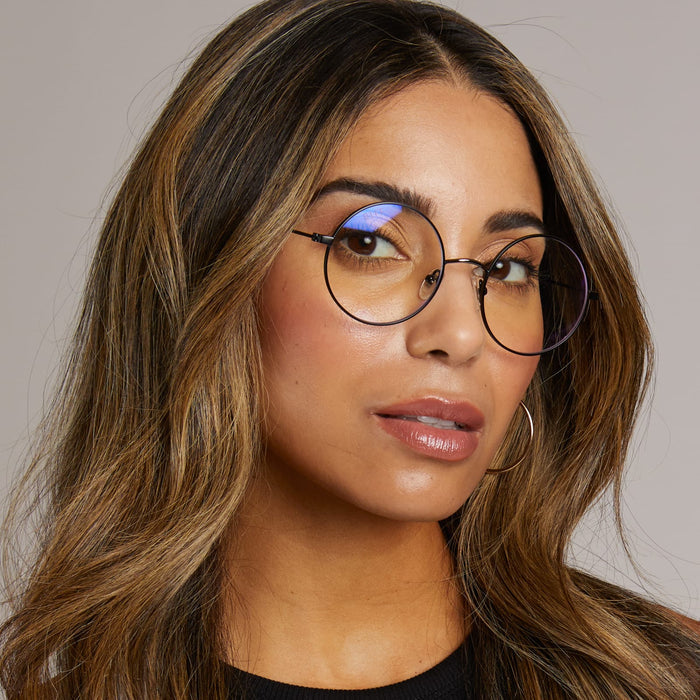 diff eyewear x harry potter female wearing harry potter glasses with chosen one black frame and prescription lenses