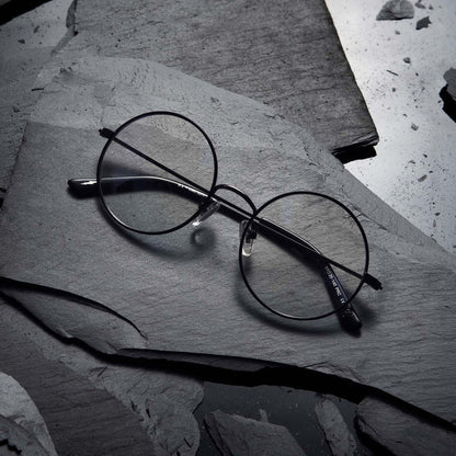 Flat-lay of Harry Potter x DIFF Harry Potter glasses lying folded on top of black broken stone