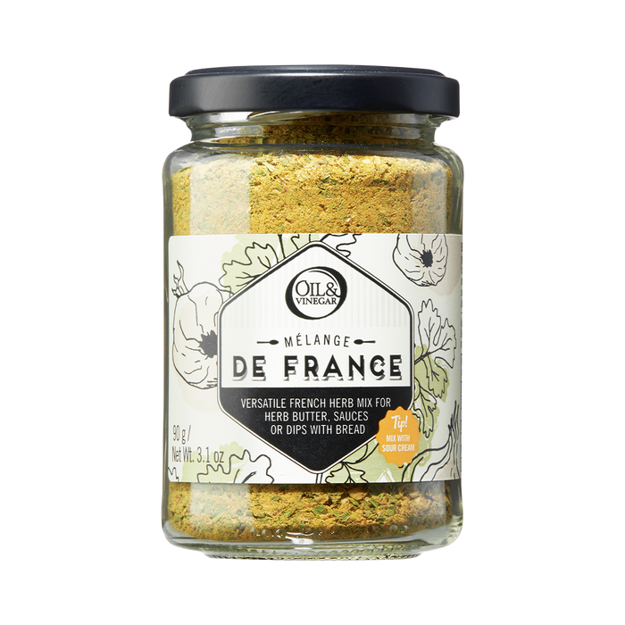 A glass jar containing Melange de France herb mix, a blend of dried herbs visible through the transparent jar.