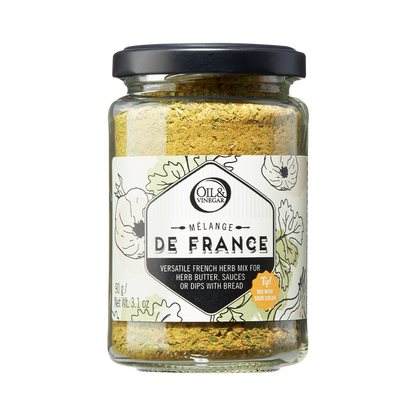 A glass jar containing Melange de France herb mix, a blend of dried herbs visible through the transparent jar.