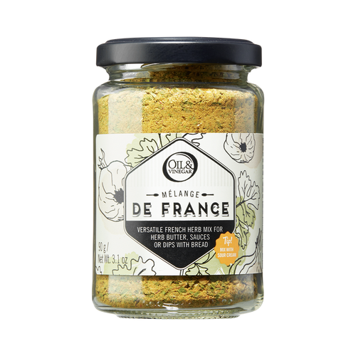 A glass jar containing Melange de France herb mix, a blend of dried herbs visible through the transparent jar.
