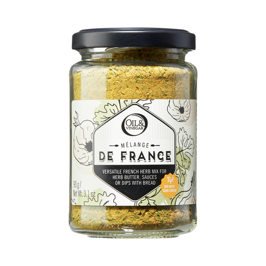 A glass jar containing Melange de France herb mix, a blend of dried herbs visible through the transparent jar.