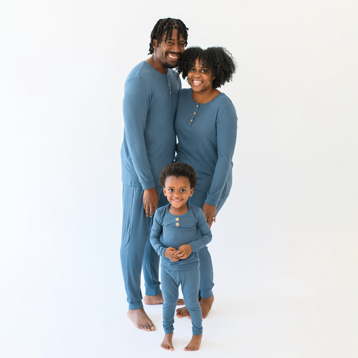 Family matching in the Ribbed Henley Sets in Atlantic. Father is standing beside mother with their child in front of them all in front of a white background