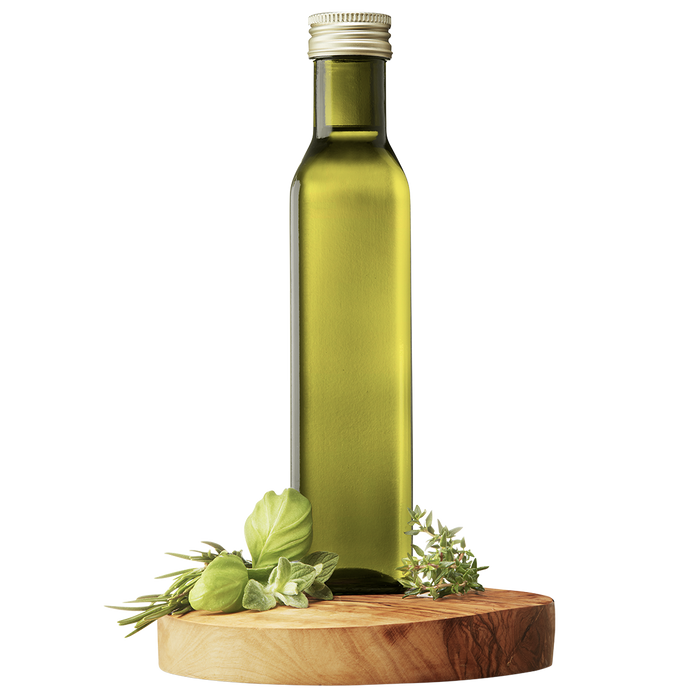 A tall, slender bottle of Tuscan Herb Extra Virgin Olive Oil on a wooden platform, flanked by fresh herbs.