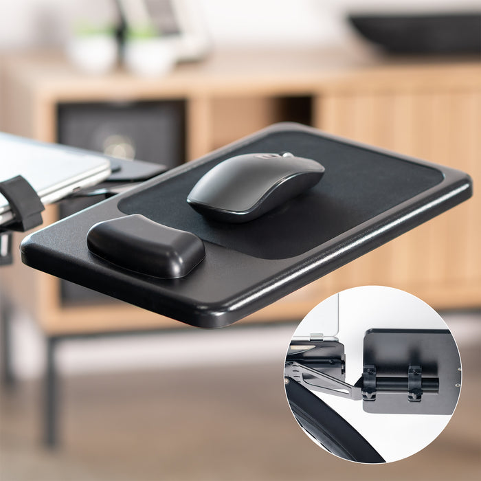 Black desk pad with a mouse on a blurred office background