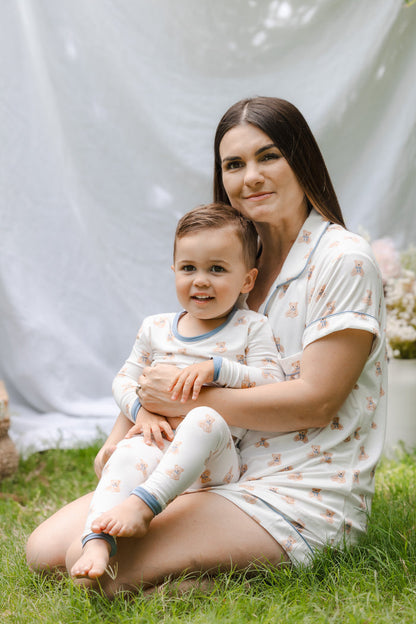Mom and toddler outdoors wearing matching teddy bear patterned pajamas